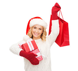 Image showing woman in santa helper hat with shopping bags