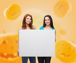 Image showing smiling teenage girls with white board