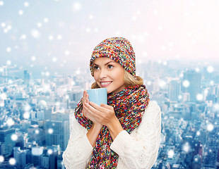 Image showing smiling young woman in winter clothes with cup