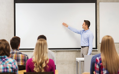 Image showing group of students and smiling teacher in classroom