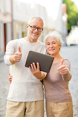 Image showing senior couple photographing on city street