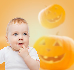 Image showing smiling baby over pumpkins background