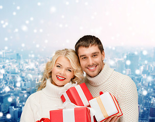 Image showing smiling man and woman with presents