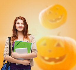 Image showing smiling student girl with books and bag