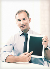 Image showing smiling businessman with tablet pc in office