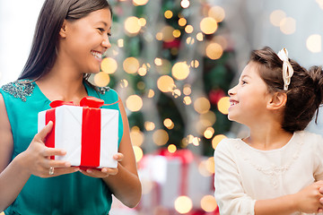 Image showing happy mother and little girl with gift box