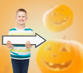 Image showing smiling little boy holding big white arrow