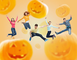 Image showing group of smiling teenagers jumping in air