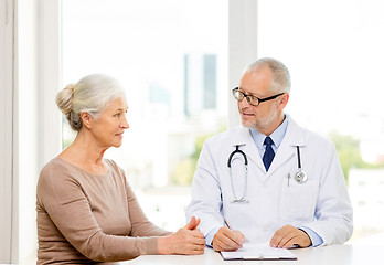 Image showing smiling senior woman and doctor meeting