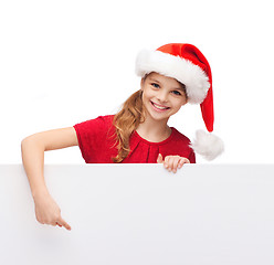 Image showing child in santa helper hat with blank white board