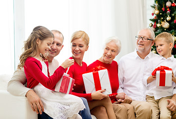 Image showing smiling family with gifts at home