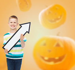 Image showing smiling little boy holding big white arrow