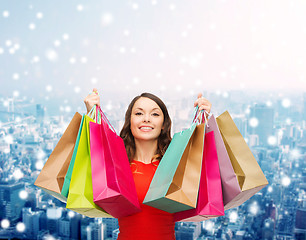 Image showing smiling woman with colorful shopping bags