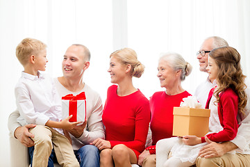 Image showing smiling family with gifts at home