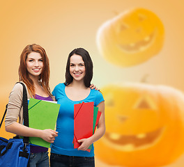 Image showing smiling student girl with books and bag