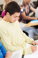 Image showing group of smiling students with notebooks