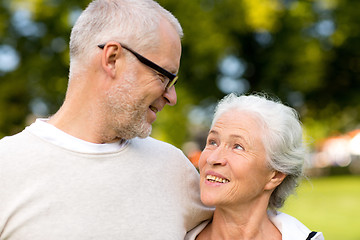 Image showing senior couple hugging in city park