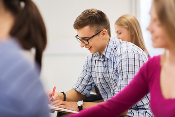 Image showing group of smiling students with notebook