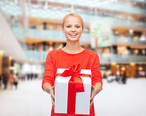 Image showing smiling woman in red clothes with gift box