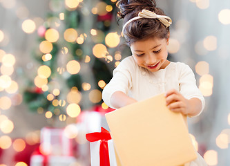 Image showing smiling little girl with gift box