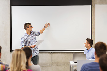 Image showing group of smiling students and teacher in classroom