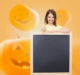 Image showing smiling little girl with blackboard