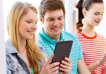 Image showing smiling students with tablet pc at school