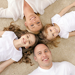 Image showing parents and two girls lying on floor at home