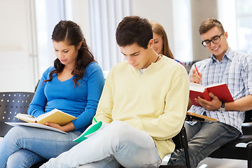 Image showing group of smiling students with notebooks