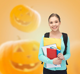 Image showing smiling student girl with books and backpack