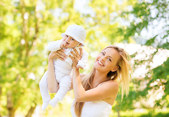 Image showing happy mother with little baby in park