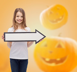 Image showing smiling little girl holding big white arrow