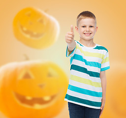 Image showing smiling boy over pumpkins background