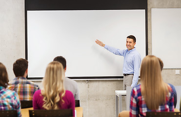 Image showing group of students and smiling teacher in classroom