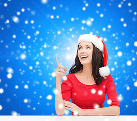 Image showing smiling woman in santa helper hat