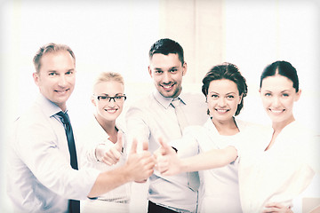 Image showing business team showing thumbs up in office