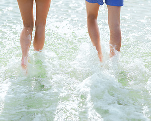 Image showing close up of human legs on summer beach