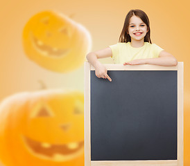 Image showing smiling little girl with blackboard