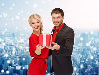 Image showing smiling man and woman with present