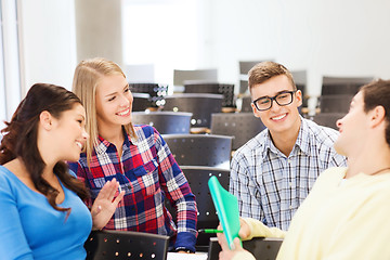 Image showing group of smiling students with notebook