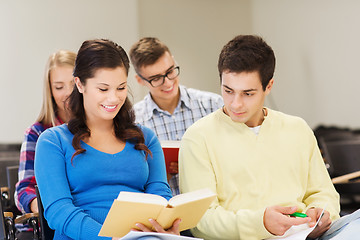 Image showing group of smiling students with notebooks