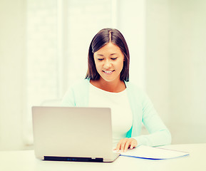 Image showing asian businesswoman with laptop and documents