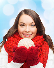 Image showing smiling woman in winter clothes with snowball