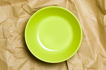 Image showing Green bowl on crumpled paper

