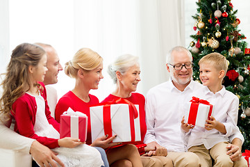 Image showing smiling family with gifts at home