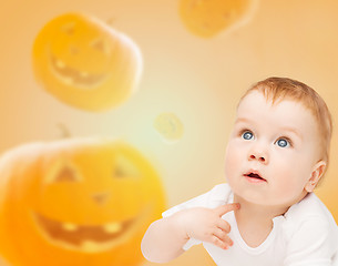 Image showing smiling baby over pumpkins background