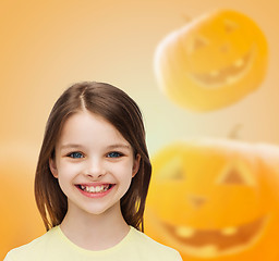 Image showing smiling girl over pumpkins background