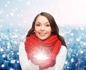 Image showing smiling woman in winter clothes with snowflake