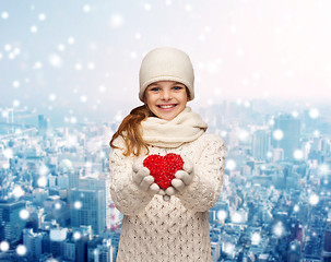 Image showing dreaming girl in winter clothes with red heart