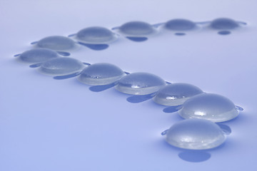 Image showing Glass pebbles on water

